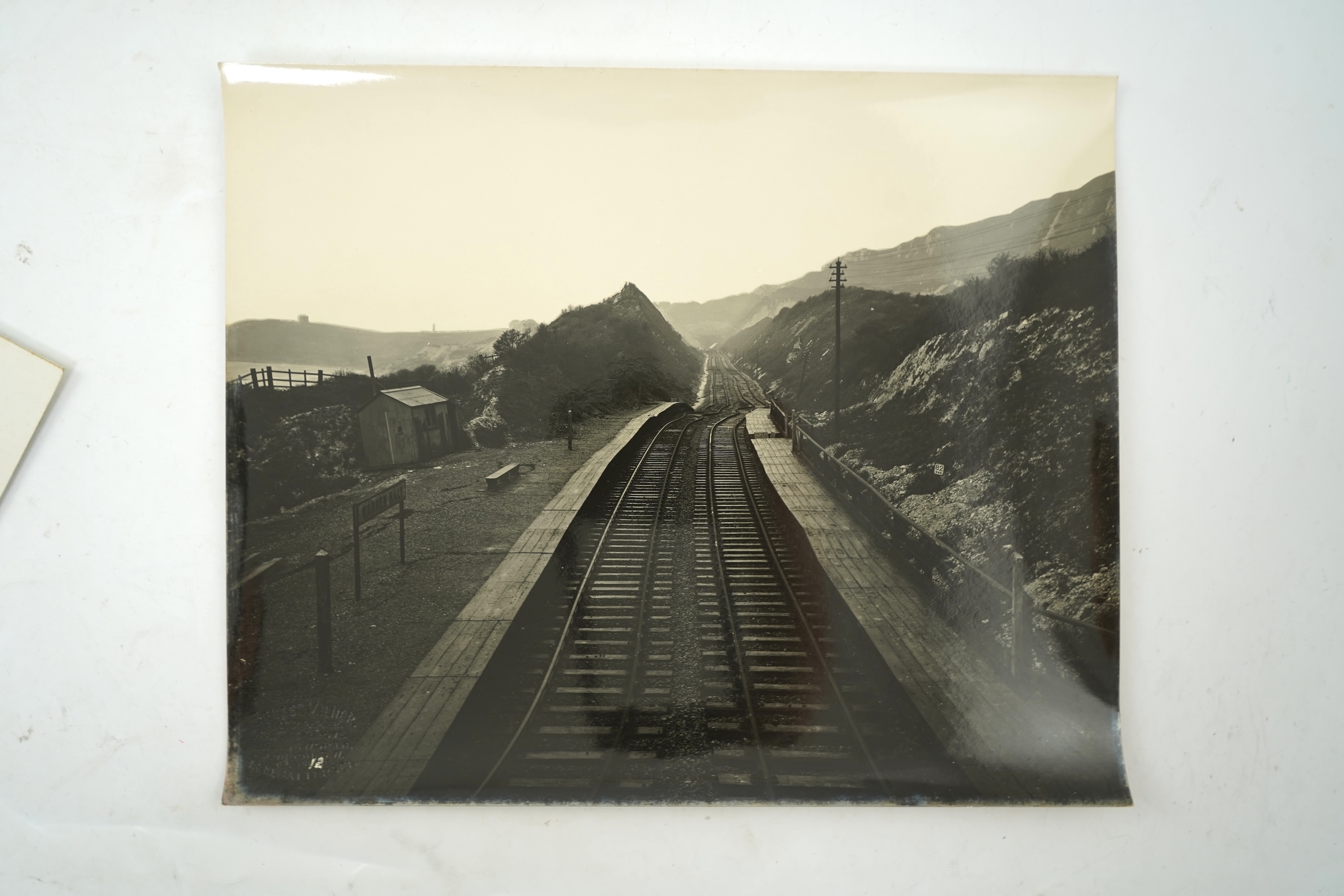 Fourteen late 19th/early 20th century black and white photographs of the results of a chalk landslide on the SE&CR, South East and Chatham Railway, at East Wear Bay, Capel-le-Ferne, Kent, with annotations to the reverse